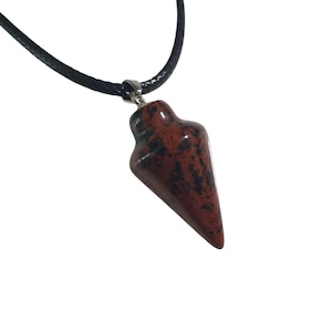 May include: A red and black stone pendulum pendant on a black cord. The pendant is a teardrop shape with a silver-colored metal loop. The stone has a speckled pattern.