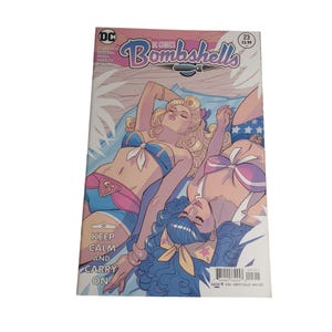 May include: DC Comics Bombshells #23 comic book cover featuring two women in swimwear. The cover art includes the text "Keep Calm and Carry On" and the comic's title. The comic is rated Teen and was released in May 2017.