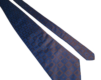 May include: A blue patterned silk tie with a geometric design. The tie has a dark blue background with a lighter blue pattern of squares.