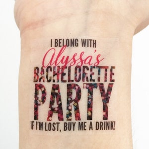 May include: A temporary tattoo with glitter and the text "I belong with Alyssa's Bachelorette Party. If I'm lost, buy me a drink!"