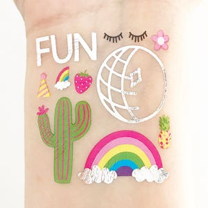 May include: A set of colorful temporary tattoos featuring a cactus, a rainbow, a disco ball, a strawberry, a flower, a party hat, eyelashes, and the word "FUN".