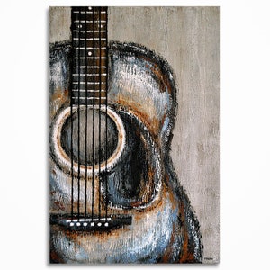Acoustic guitar painting with a distressed, textured finish. The artwork features a close-up of the guitar's body, sound hole, and neck, with visible strings. The color palette includes shades of gray, brown, and blue, creating a vintage aesthetic. Signed Magier in the bottom right corner.