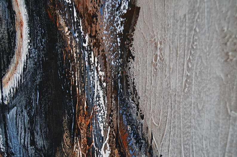 May include: Abstract painting with a textured surface. The artwork features a blend of dark brown, black, white, and blue hues, with a light beige area on the right side. The paint is applied in thick strokes.