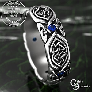 May include: Sterling silver ring with a Celtic knot design and two blue gemstones. The ring is made in the USA.