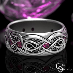 May include: A silver Celtic knot ring with a design of intertwined infinity symbols. The ring is adorned with five pink gemstones.