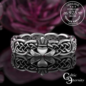 Puede incluir: Un anillo Claddagh de plata de ley con un diseño de corazón, corona y manos. El anillo presenta intrincados nudos celtas y el texto "GENUINE STERLING 925 SILVER hand crafted nickel free MADE IN THE USA" y "Celtic Eternity".