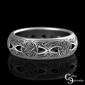 May include: A silver Celtic knot ring with an intricate design. The ring is wide and has a polished finish.