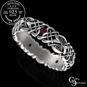 May include: A Celtic knot ring made from sterling silver, featuring a red gemstone. The ring is hand-crafted and nickel-free. The image includes the text "Genuine Sterling 925 Silver" and "Made in the USA".