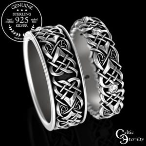 May include: Two sterling silver Celtic knot wedding bands with a diamond accent. The bands are intricately designed with a Celtic knot pattern and feature a small diamond on each band.