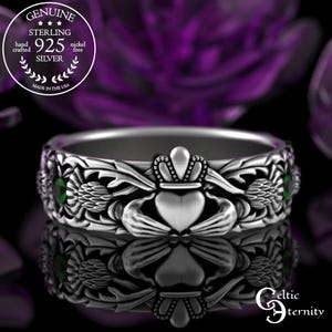 May include: Sterling silver Claddagh ring with green gemstones and intricate Celtic knotwork design. The ring features a heart, hands, and crown.