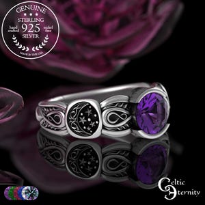 May include: Sterling silver ring with a purple gemstone and a celestial design. The ring features a moon and star motif on a black background, with intricate detailing. The ring is marked "925 Silver" and "Made in the USA".