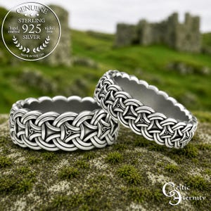 May include: Two sterling silver rings featuring an intricate, continuous woven knot pattern with scalloped edges. A circular emblem in the upper left corner displays the text Genuine Sterling 925 Silver Hand Crafted Nickel Free Made in the USA.