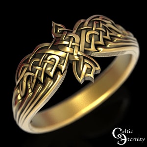 May include: A gold Celtic knot ring with a detailed design. The knot is in the shape of a bird with its wings spread. The ring is made of polished metal and has a smooth finish.