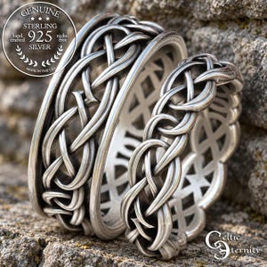 May include: Two sterling silver rings featuring an intricate, openwork braided knot pattern. The metal has a polished, antiqued finish. A circular emblem on the left reads: GENUINE STERLING 925 SILVER hand crafted nickel free MADE IN THE USA.
