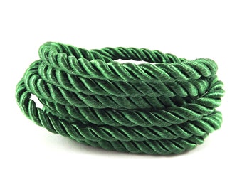 May include: A close-up of a green twisted rope cord. The cord is made of a soft, pliable material and is perfect for crafting projects.
