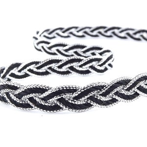 May include: Black and silver braided trim with a woven design.