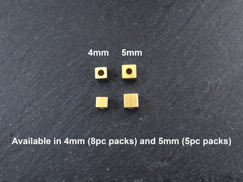 May include: Four small, square, gold-colored beads, 4mm and 5mm in size, are displayed. The image includes the text "Available in 4mm (8pc packs) and 5mm (5pc packs)". These beads are ideal for jewelry making and crafting.