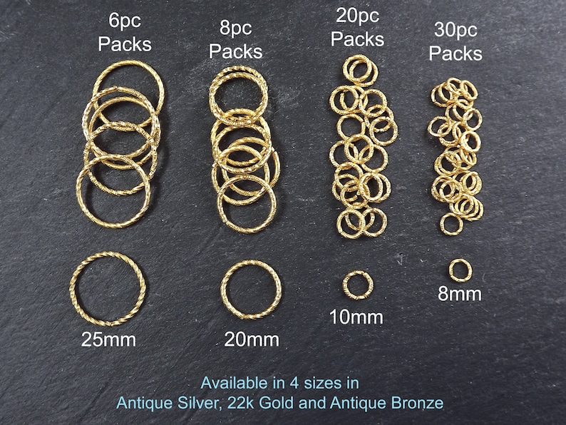 May include: Gold jump rings in four sizes: 8mm, 10mm, 20mm, and 25mm.  The rings are available in packs of 6, 8, 20, and 30.  The text "Available in 4 sizes in Antique Silver, 22k Gold and Antique Bronze" is at the bottom of the image.