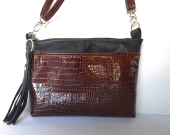 Brown patent leather croc with smooth black leather trim, crossbody or shoulder bag.  Brown leather crossbody bag with back leather trim.