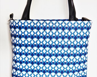 Blue and white geometric print leather, with black leather trim, shoulder bag, with crossbody strap.