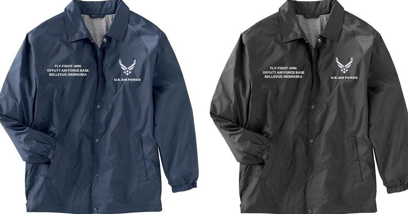 May include: Two jackets, one navy blue and one black, with a white embroidered patch on the left sleeve. The patch features the U.S. Air Force logo and the text "FLY FIGHT WIN OFFUTT AIR FORCE BASE BELLEVUE NEBRASKA US AIR FORCE".