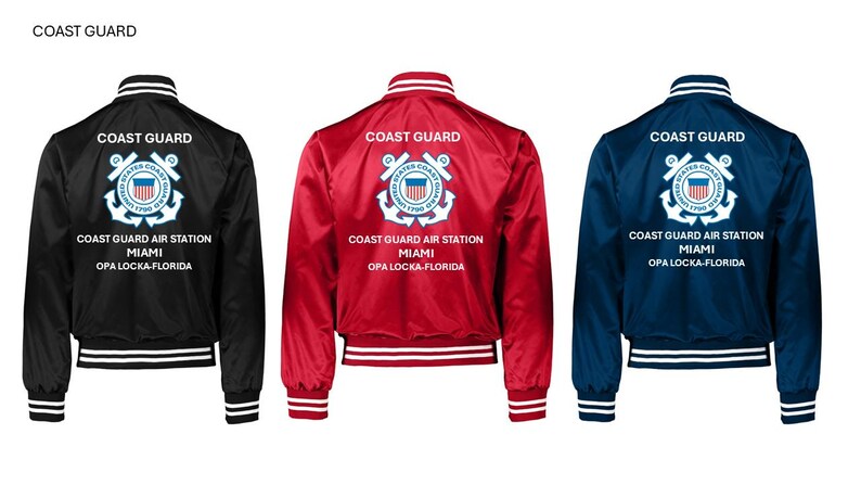 May include: Three satin bomber jackets in black, red, and navy blue. Each jacket features the words "COAST GUARD" and "COAST GUARD AIR STATION MIAMI OPA LOCKA-FLORIDA" printed on the back. The jackets have white and black striped cuffs, collars, and hems.