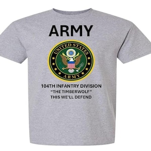 May include: A gray t-shirt with a black print of the words "ARMY" and the United States Army seal. The seal is green, gold, and red with a bald eagle and the words "UNITED STATES ARMY". Below the seal is the text "104TH INFANTRY DIVISION" "THE TIMBERWOLF" "THIS WE'LL DEFEND".