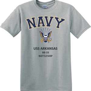 May include: A gray t-shirt with a navy blue "NAVY" text and a gold eagle emblem. The text "USS ARKANSAS BB-33 BATTLESHIP" is printed below the emblem.