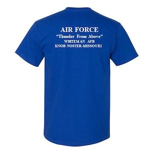 May include: A royal blue t-shirt with white text that reads "AIR FORCE" "Thunder From Above" Whiteman AFB Knob Noster-Missouri.