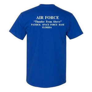 May include: Royal blue t-shirt with white text that reads "AIR FORCE" "Thunder From Above" PATRICK SPACE FORCE BASE FLORIDA