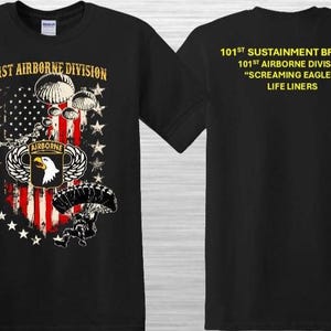 May include: Black t-shirt featuring the 101st Airborne Division emblem with an American flag design, parachutes, and the text "101st Airborne Division." The back of the shirt displays text: "101st Sustainment Brigade, Screaming Eagles, Life Liners."