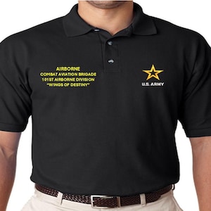 May include: Black polo shirt with yellow embroidered text that reads "AIRBORNE COMBAT AVIATION BRIGADE 101ST AIRBORNE DIVISION "WINGS OF DESTINY" and a yellow star with the text "U.S. ARMY" below it.