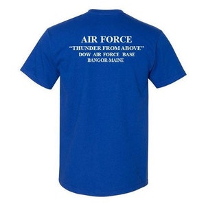 May include: Royal blue t-shirt with white text that reads "AIR FORCE "THUNDER FROM ABOVE" DOW AIR FORCE BASE BANGOR-MAINE"