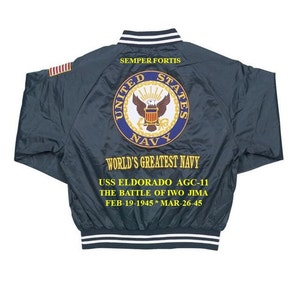 May include: A dark blue bomber jacket with a white and black striped collar and cuffs. The back of the jacket features an embroidered United States Navy seal with the words "SEMPER FORTIS", "UNITED STATES NAVY", "WORLD'S GREATEST NAVY", "USS ELDORADO AGC-11", "THE BATTLE OF IWO JIMA", "FEB-19-1945* MAR-26-45".