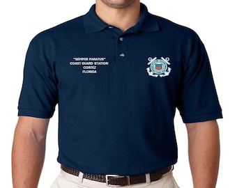 May include: A navy blue polo shirt with the Coast Guard emblem embroidered on the right chest. The text "SEMPER PARATUS" COAST GUARD STATION CORTEZ FLORIDA is embroidered on the left chest.