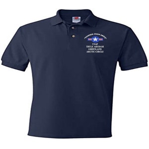 May include: A navy blue polo shirt with a white embroidered design that reads "Thunder From Above" with a US Air Force logo and the text "USAF Thule Air Base Greenland Arctic Circle".