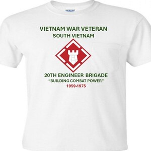 May include: White t-shirt with a pocket, featuring green text that reads "VIETNAM WAR VETERAN SOUTH VIETNAM." Below is a red and white emblem and text that reads "20TH ENGINEER BRIGADE BUILDING COMBAT POWER 1959-1975."