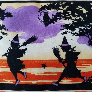 May include: Two black silhouettes of witches with purple hats and brooms flying over a sunset with a black silhouette of an owl perched on a branch.