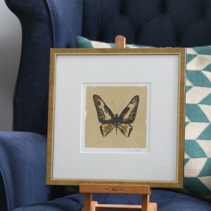 Hand painted butterfly in pen and ink silhouette on gold leaf on paper. image 1
