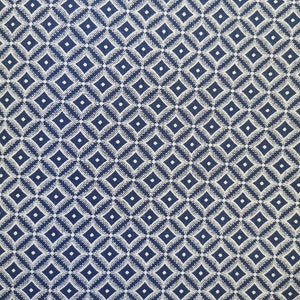 May include: Blue fabric with a white diamond pattern. The fabric is measured with a ruler in inches.