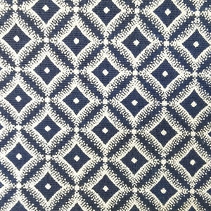 May include: A navy blue fabric with a white diamond pattern. The diamonds are made up of small white dots.