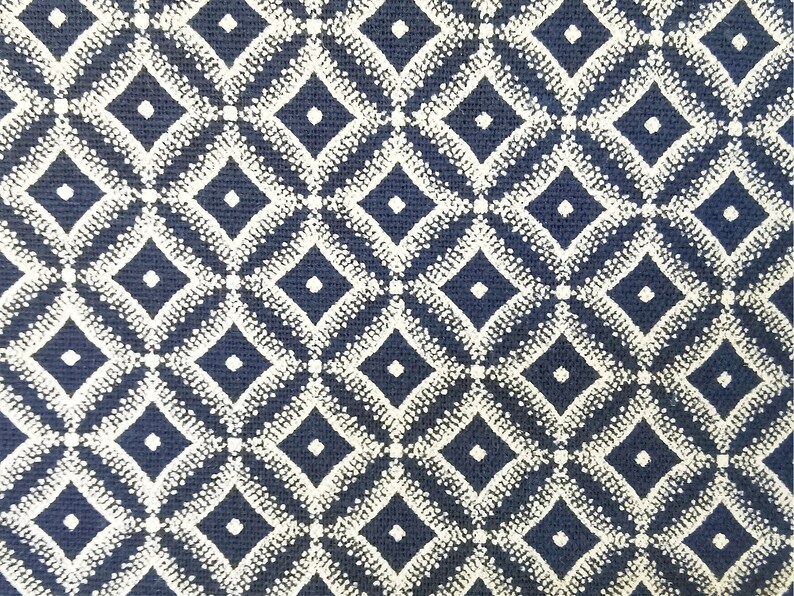 May include: A navy blue fabric with a white diamond pattern. The diamonds are made up of small white dots.