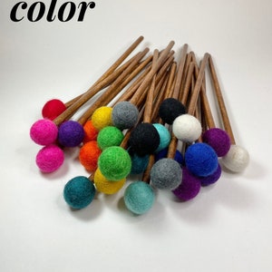 May include: A collection of colorful felt-tipped mallets with wooden handles. The mallets are arranged in a pile, with the felt tips facing up. The text "choose your color" is visible at the top of the image.