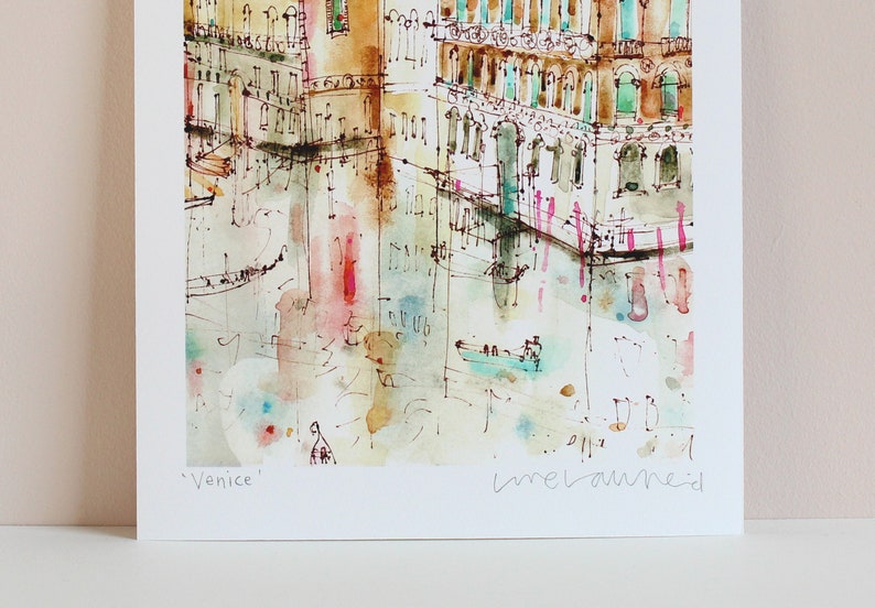 May include: A watercolour painting of a canal in Venice, Italy. The painting features buildings with colourful facades and a gondola in the water. The artist's signature, "imelaureid", is visible in the bottom right corner. The painting is titled "Venice".