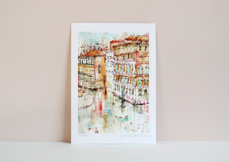 May include: Watercolour painting of a canal in Venice, Italy. The painting features buildings with colourful facades and reflections in the water. The text "Venice" and "melawred" are visible in the bottom right corner.
