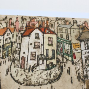 May include: A watercolor illustration of a street scene in a small town. The buildings are drawn in a whimsical style with brown, white, and red brick. The street is lined with shops and houses, and there are people walking around. The illustration is done in a muted color palette, with shades of brown, gray, and white.