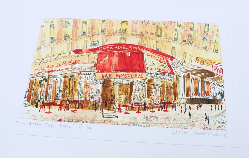 May include: Watercolor print of the Cafe des 2 Moulins in Paris, with a red awning and outdoor seating. The artwork features the text "CAFE des 2 Moulins" and "BAR BRASSERIE". The print is numbered 39/150 and signed.