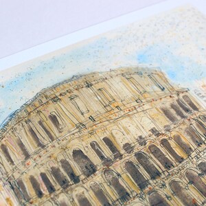 May include: Watercolor painting of the Colosseum in Rome. The artwork features the iconic amphitheater in a detailed sketch with brown and beige tones. The sky is a light blue with watercolor splatters, and green and orange accents are visible.