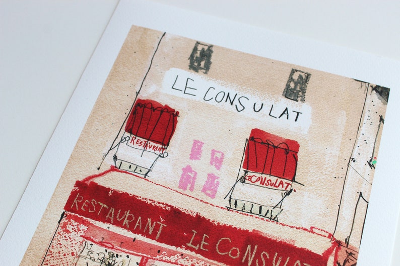 May include: A watercolor illustration of a building with the text "LE CONSULAT" written above the entrance. The building has two windows with red awnings and the text "RESTAURANT" written on one of the awnings. The building is painted in a light brown color.