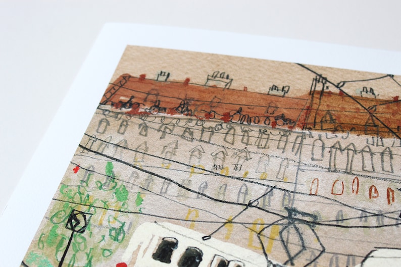 May include: A watercolor painting of a city scene with a tram in the foreground. The tram is white with black windows and is surrounded by buildings with red roofs. The buildings are drawn in a simple style with black lines and brown watercolor washes. There are power lines running across the scene.